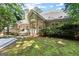 Beautiful backyard featuring a deck with seating, lush greenery, and a view of the surrounding trees at 3600 Goldenrod Dr, Alpharetta, GA 30005
