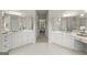Large bathroom with dual vanities, tile floor, large mirrors and decorative lighting at 3600 Goldenrod Dr, Alpharetta, GA 30005