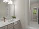 Neutral colored bathroom with a single sink vanity, white countertop, and large framed mirror at 3600 Goldenrod Dr, Alpharetta, GA 30005