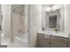 Bright bathroom featuring a shower-tub combo and a single sink vanity with a large mirror at 3600 Goldenrod Dr, Alpharetta, GA 30005