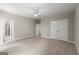 Carpeted bedroom with double closets and access to other rooms via multiple doors at 3600 Goldenrod Dr, Alpharetta, GA 30005