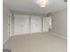 Spacious bedroom featuring neutral carpet, overhead lighting and double door closets at 3600 Goldenrod Dr, Alpharetta, GA 30005