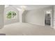 Large carpeted bedroom with arched window, dormers, and ensuite bath at 3600 Goldenrod Dr, Alpharetta, GA 30005