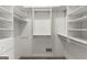 Walk-in closet featuring built-in storage shelves and a hanging rod at 3600 Goldenrod Dr, Alpharetta, GA 30005