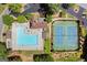 Aerial view of a community pool, clubhouse, tennis courts, parking, and landscaping at 3600 Goldenrod Dr, Alpharetta, GA 30005