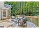 Exterior back deck with outdoor seating and a view of the wooded backyard at 3600 Goldenrod Dr, Alpharetta, GA 30005