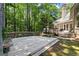Expansive wooden deck with built-in seating, surrounded by mature trees for privacy at 3600 Goldenrod Dr, Alpharetta, GA 30005