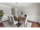 Charming dining room with a stylish chandelier, classic wainscoting, and beautiful hardwood floors at 3600 Goldenrod Dr, Alpharetta, GA 30005