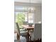 Bright dining room with a modern chandelier, six chairs, and a view to the backyard at 3600 Goldenrod Dr, Alpharetta, GA 30005