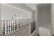 Hallway with stairs and railings overlooking a living area with a chandelier at 3600 Goldenrod Dr, Alpharetta, GA 30005