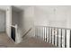 Hallway featuring dark wood and white banister leading to the foyer with elegant light fixture at 3600 Goldenrod Dr, Alpharetta, GA 30005