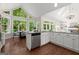 Sunlit kitchen with hardwood floors, granite countertops, stainless appliances and a breakfast nook with large windows at 3600 Goldenrod Dr, Alpharetta, GA 30005