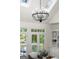 Living room with a chandelier and doors to an outdoor deck at 3600 Goldenrod Dr, Alpharetta, GA 30005