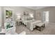 Elegant bedroom with large windows, neutral tones, and a seating area for relaxation at 3600 Goldenrod Dr, Alpharetta, GA 30005
