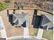 An aerial view of a home showcasing the roof, backyard with fence, and proximity to surrounding landscapes at 10736 Southwood Dr, Hampton, GA 30228