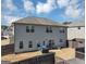 View of the backyard with a gray house and a new wooden fence around the parameter at 10736 Southwood Dr, Hampton, GA 30228