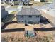 Aerial view of the backyard with a gray house and a new wooden fence around the parameter at 10736 Southwood Dr, Hampton, GA 30228