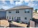 View of the backyard with a gray house and a new wooden fence around the parameter at 10736 Southwood Dr, Hampton, GA 30228