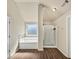 Bright bathroom featuring a window above the soaking tub and a separate glass shower at 10736 Southwood Dr, Hampton, GA 30228