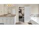Bathroom featuring double sink vanity, and a soaking tub with a view to the bedroom at 10736 Southwood Dr, Hampton, GA 30228