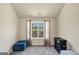 A room with a window that has sheer curtains, with a blue bench in the corner at 10736 Southwood Dr, Hampton, GA 30228