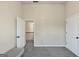 Bedroom with neutral walls, carpet floors, and two white doors at 10736 Southwood Dr, Hampton, GA 30228