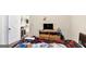 Simple bedroom with light-colored walls, unmade bed and basic furniture at 10736 Southwood Dr, Hampton, GA 30228