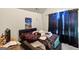 Cluttered bedroom with dark blinds, desk, bed with busy covers and a small television at 10736 Southwood Dr, Hampton, GA 30228