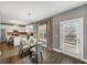 Dining area with a modern glass table, chairs, and sliding glass doors to a deck at 10736 Southwood Dr, Hampton, GA 30228