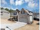 Beautiful brick home with a two-car garage, covered entry, and well-manicured lawn at 10736 Southwood Dr, Hampton, GA 30228