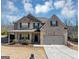 Charming brick home featuring a two-car garage, covered porch, and well-maintained landscaping at 10736 Southwood Dr, Hampton, GA 30228