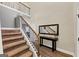 Elegant foyer boasts hardwood floors, staircase, and stylish console table with decor at 10736 Southwood Dr, Hampton, GA 30228