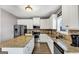 Well-equipped kitchen with stainless steel appliances and granite countertops, and breakfast bar at 10736 Southwood Dr, Hampton, GA 30228