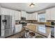 Modern kitchen with stainless steel appliances, granite countertops, and a breakfast bar at 10736 Southwood Dr, Hampton, GA 30228