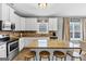 Modern kitchen with stainless steel appliances, granite countertops, and a breakfast bar at 10736 Southwood Dr, Hampton, GA 30228