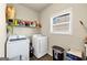 Bright laundry room with newer washer and dryer at 10736 Southwood Dr, Hampton, GA 30228