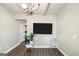 Cozy living room with a large TV, modern chair, and wood floors at 10736 Southwood Dr, Hampton, GA 30228