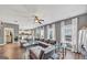 Open-concept living room with hardwood floors, modern furniture, and plenty of natural light at 10736 Southwood Dr, Hampton, GA 30228