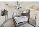 Main bedroom features a ceiling fan, en-suite bathroom, and a TV at 10736 Southwood Dr, Hampton, GA 30228