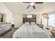 Main bedroom features a ceiling fan, en-suite bathroom, and nice lamps at 10736 Southwood Dr, Hampton, GA 30228