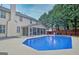 Beautiful backyard with an in-ground swimming pool, screen porch and mature trees at 500 Merrill Ln, Peachtree City, GA 30269