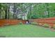 Backyard with a small fire pit and wood pile surrounded by a wood fence at 500 Merrill Ln, Peachtree City, GA 30269