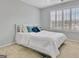 This bright bedroom features shutters on the window and neutral carpet at 500 Merrill Ln, Peachtree City, GA 30269
