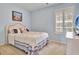 Comfortable bedroom features natural light from window with plantation shutters at 500 Merrill Ln, Peachtree City, GA 30269