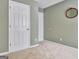 Neutral bedroom features light green walls, neutral carpet and white paneled doors at 500 Merrill Ln, Peachtree City, GA 30269