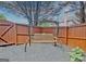 Bench swing surrounded by a wood privacy fence and covered in shade trees at 500 Merrill Ln, Peachtree City, GA 30269