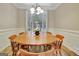 Light-filled dining area showcasing a wooden table set and shuttered windows at 500 Merrill Ln, Peachtree City, GA 30269