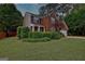 Charming two-story brick home with a well-manicured lawn and long driveway at 500 Merrill Ln, Peachtree City, GA 30269