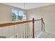 Bright upstairs hallway features natural light and wood railing at 500 Merrill Ln, Peachtree City, GA 30269