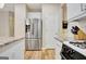 Kitchen showcasing granite countertops, stainless steel refrigerator, and modern appliances at 500 Merrill Ln, Peachtree City, GA 30269